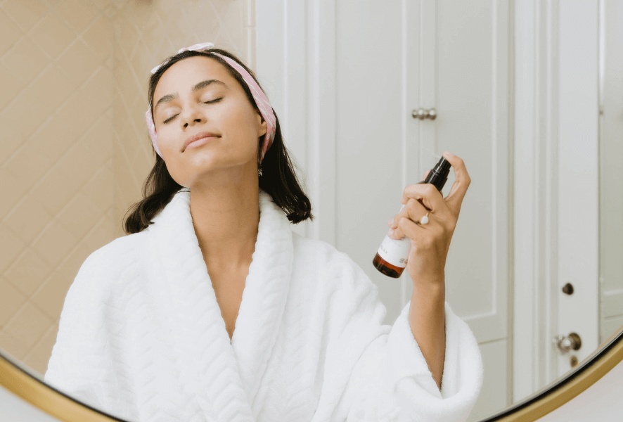 Woman in front of mirror doing skin care